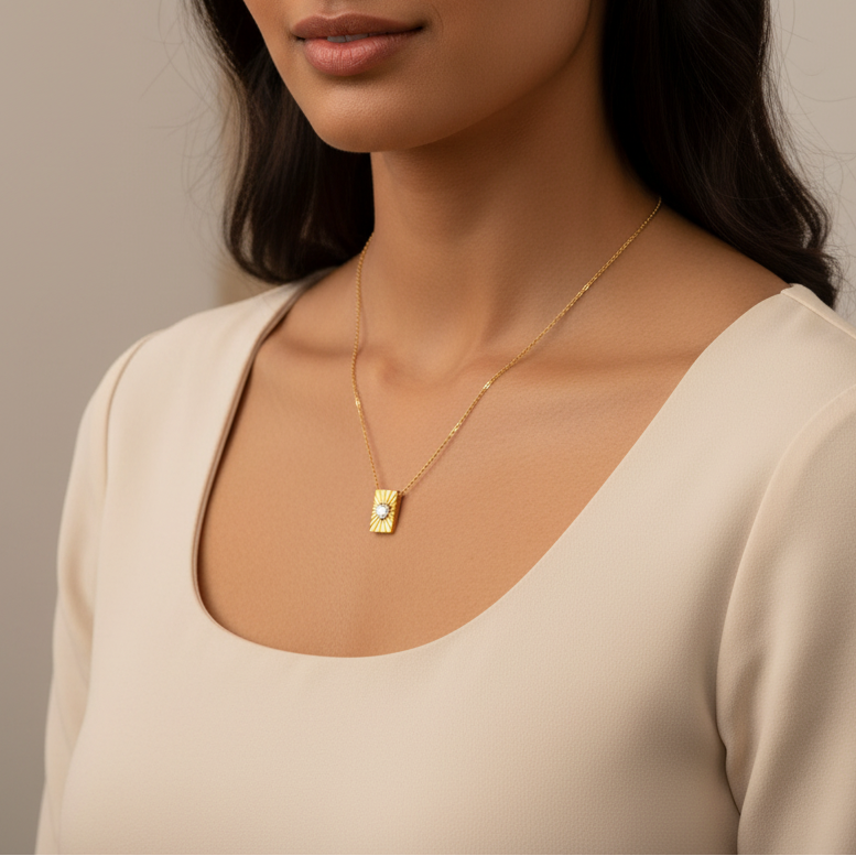 Gold necklace with a heart-shaped pendant on a model