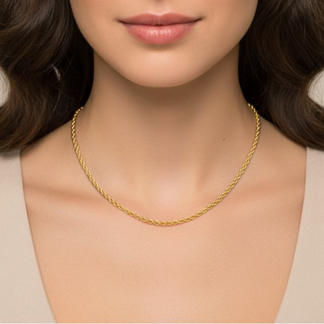Gold necklace worn by a model with a neutral background