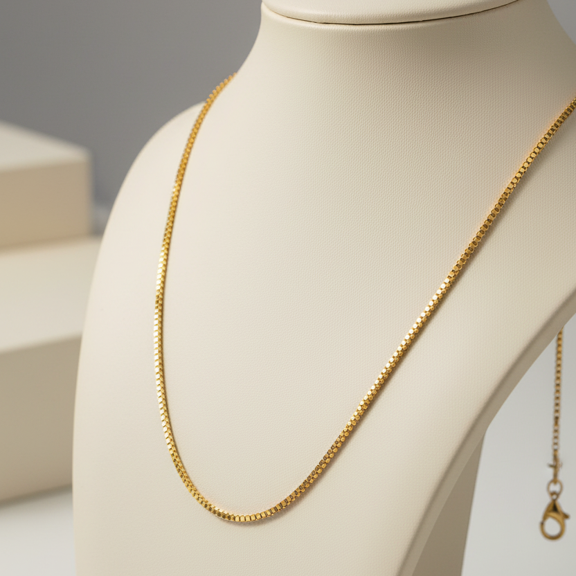 Gold necklace on a mannequin with a neutral background
