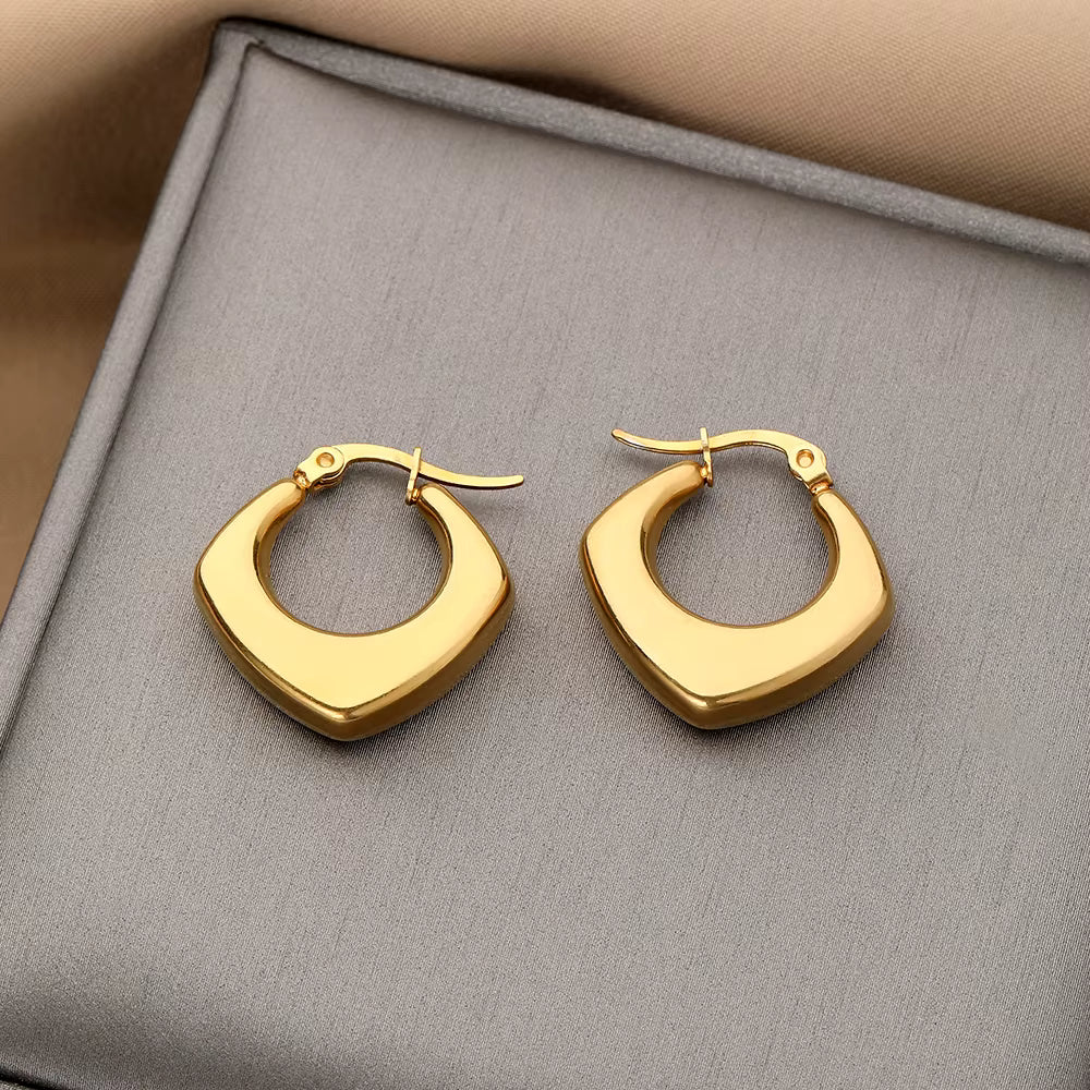 Minimal mini rectangular gold huggie hoops for everyday wear.
