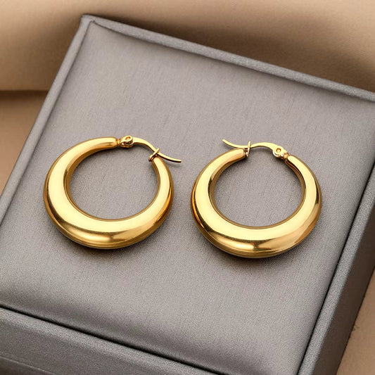 Simple polished gold hoops designed for everyday office wear.