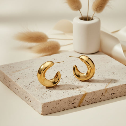 Sleek crescent-shaped gold hoops with a polished minimal finish.