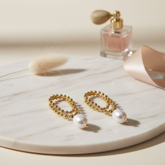 Elegant gold beaded hoops finished with a smooth pearl drop.