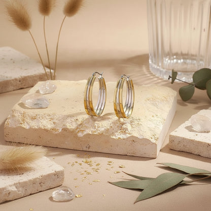 Sleek mixed-metal triple-band hoops with an elongated silhouette.