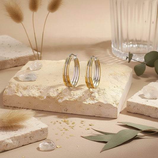 Sleek mixed-metal triple-band hoops with an elongated silhouette.