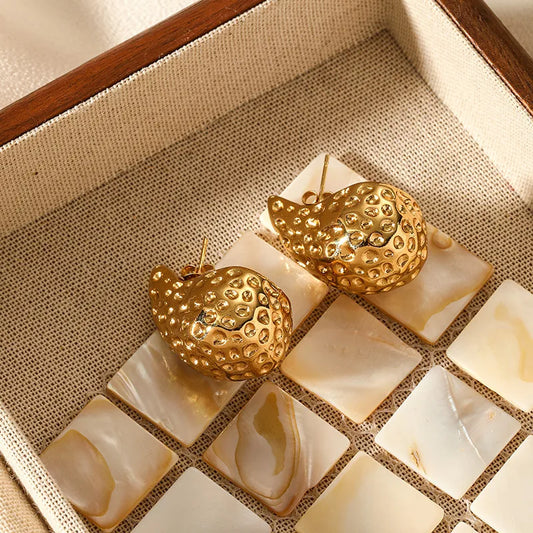 Bold sculpted gold droplet studs with geometric bubbled texture.
