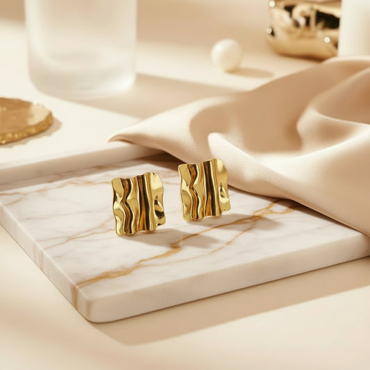 Sculpted molten-style rectangular gold studs with a soft curved finish.