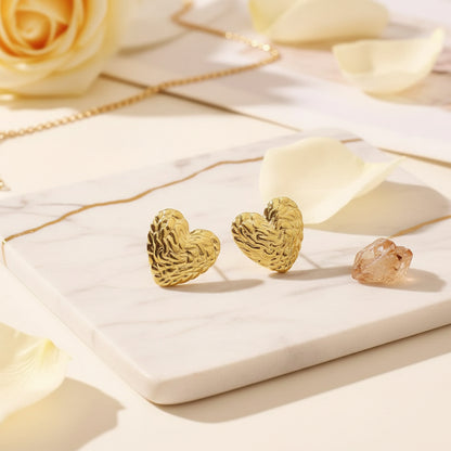 Softly textured gold heart studs for romantic everyday shine.