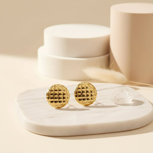 Modern gold circle studs with sculpted geometric cutouts.