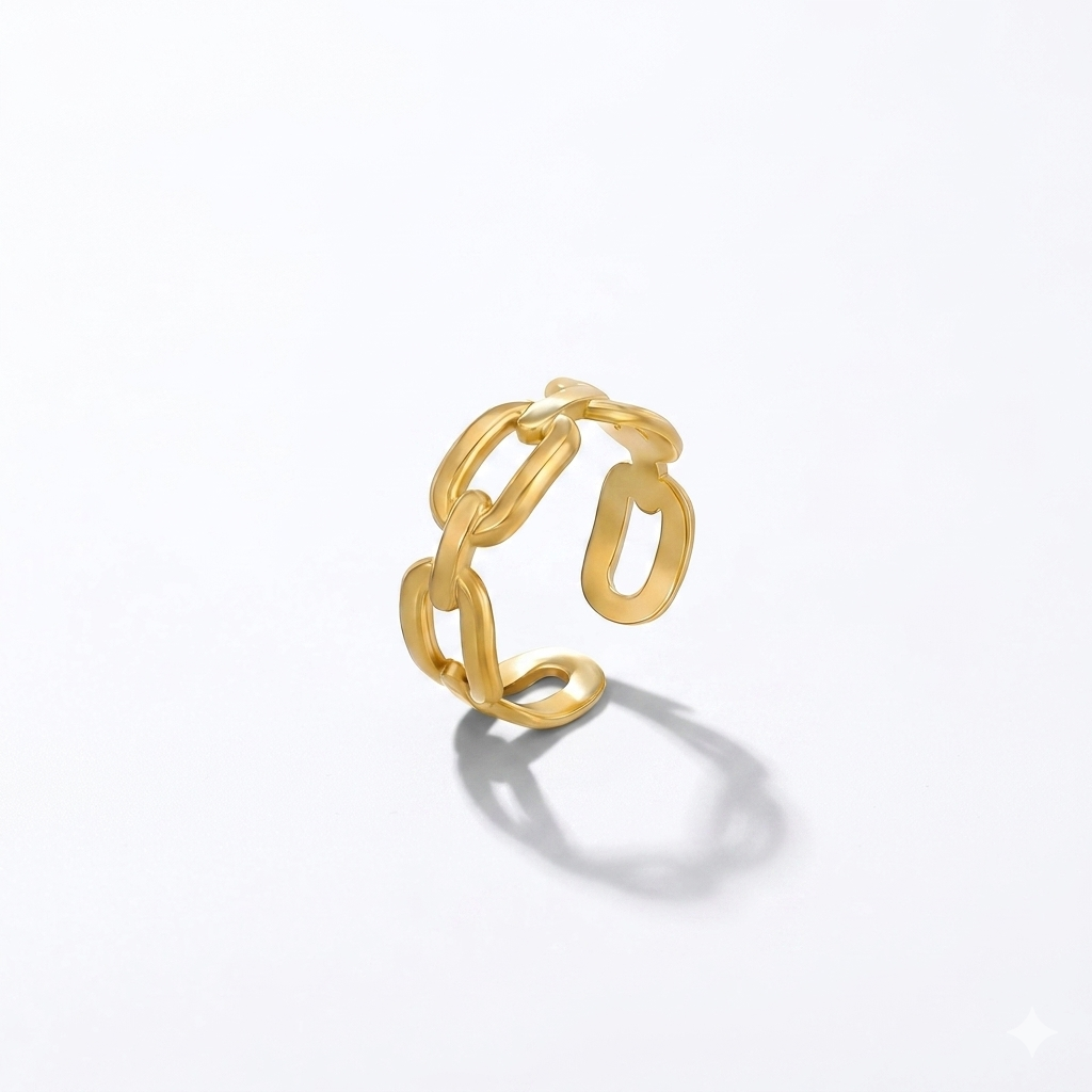 Gold chain-style ring on a light gray background