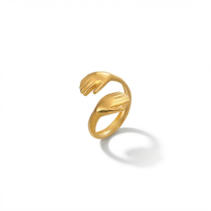 Gold ring with a unique hug design on a white background